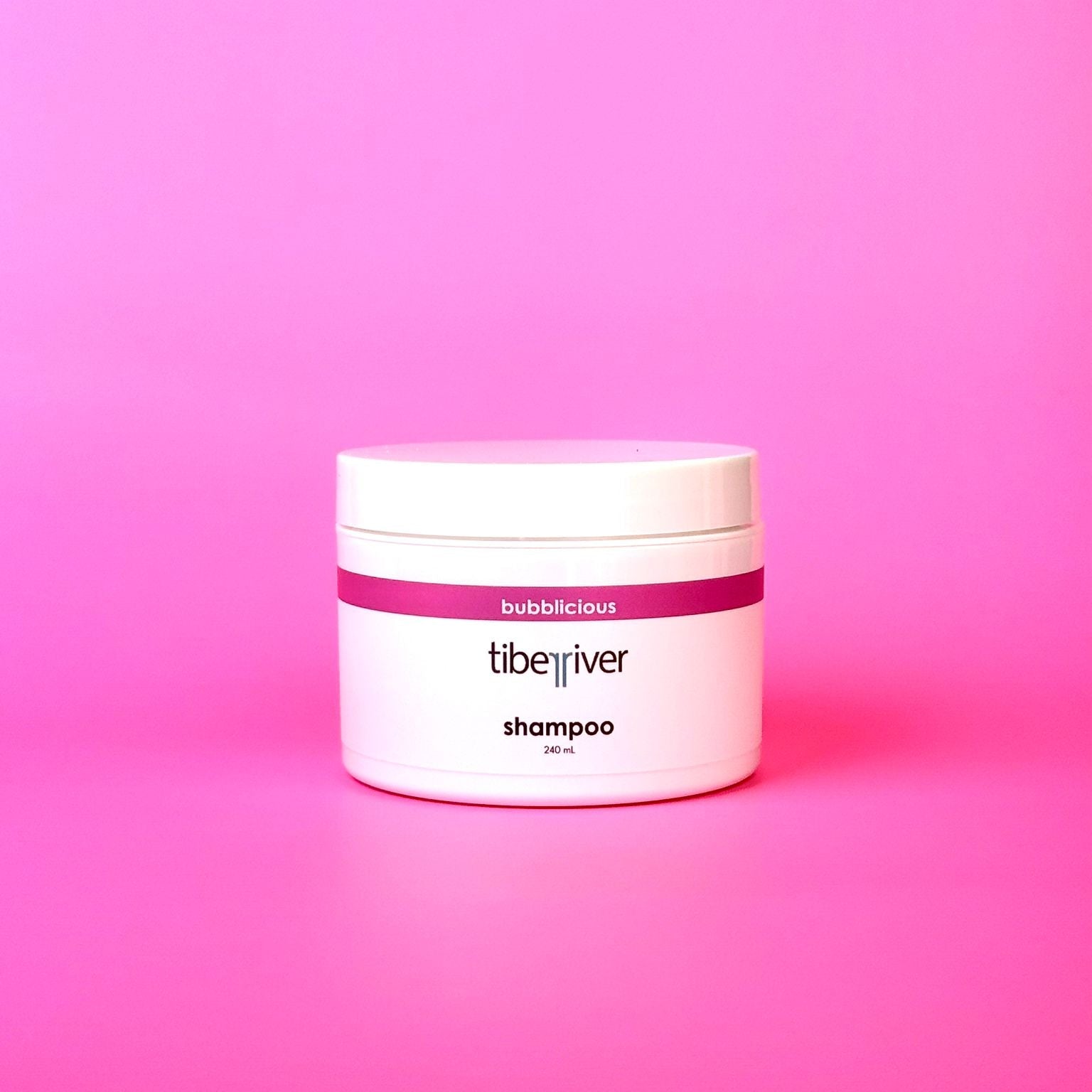 Tiberiver shampoo jar on a pink background